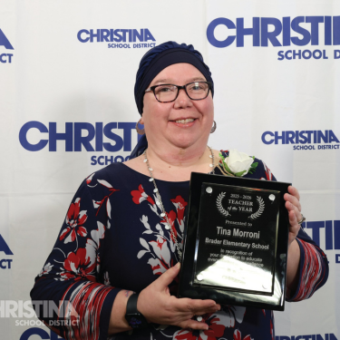 Photo of Tina Morroni Brader Teacher of the Year holding plaque